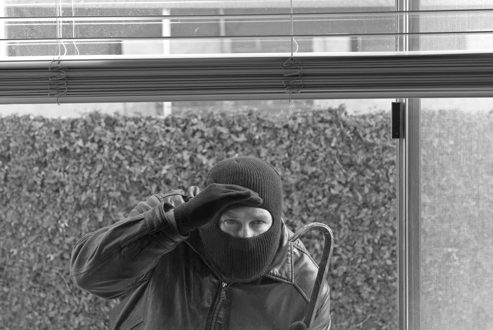 Peering Burglar With Crowbar Contemplates Property Crimes